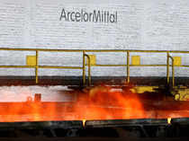 FILE PHOTO: FILE PHOTO: The logo of ArcelorMittal is pictured in front of heat rising from a red-hot steel plate at the ArcelorMittal steel plant in Ghent