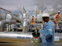 FILE PHOTO: Cairn India employees work at a storage facility for crude oil at Mangala oil field at Barmer in the desert Indian state of Rajasthan