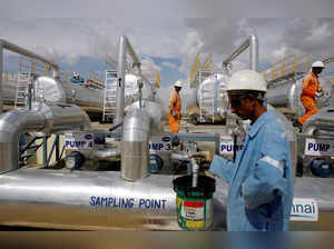 FILE PHOTO: Cairn India employees work at a storage facility for crude oil at Mangala oil field at Barmer in the desert Indian state of Rajasthan