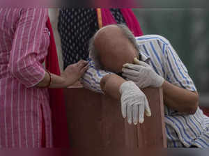 A man reacts before the cremation of his relative