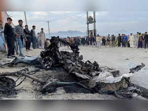 People stand at the site of a blast in Kabul