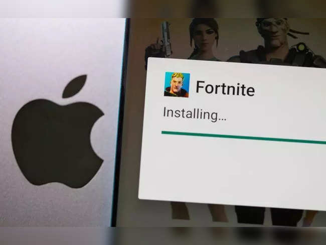 FILE PHOTO: Fortnite installing on Android is seen in front of Apple logo in this illustration