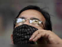 Mumbai: A man watches stock prices on a digital screen on the facade of Bombay S...