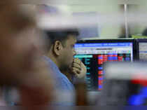 A broker reacts while trading at his computer terminal at a stock brokerage firm in Mumbai