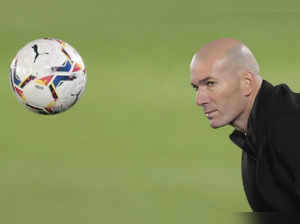 Madrid : Real Madrid's head coach Zinedine Zidane eyes a ball during the Spanish...
