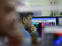 FILE PHOTO: A broker reacts while trading at his computer terminal at a stock brokerage firm in Mumbai