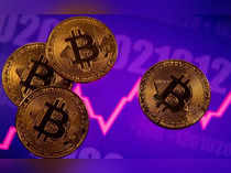 FILE PHOTO: A representation of virtual currency Bitcoin is seen in front of a stock graph
