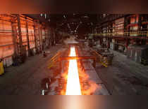 FILE PHOTO: Steam rolls off a slab of steel as it rolls down the line at the Novolipetsk Steel PAO steel mill in Farrell