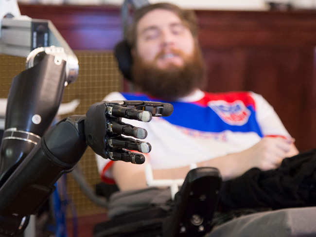 The world's first brain-computer interface allows a volunteer with paralysis from the chest down to accomplish this sensation.