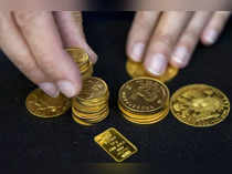 FILE PHOTO: A worker places gold bullion on display at Hatton Garden Metals precious metal dealers in London