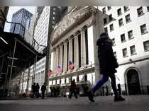 FILE PHOTO: People are seen on Wall Street outside the NYSE in New York