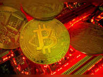 FILE PHOTO: Representations of the virtual currency Bitcoin stand on a motherboard in this picture illustration
