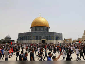 Palestinians walk at the compound that houses Al-Aqsa Mosque in Jerusalem's Old City