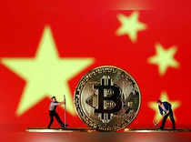 FILE PHOTO: Picture illustration of small toy figurines and representations of the Bitcoin virtual currency displayed in front of an image of China's flag
