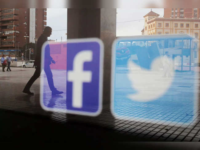 FILE PHOTO: Facebook and Twitter logos are seen on a shop window in Malaga