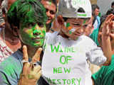 A Trinamool Congress activist flashes Victory sign during celebration