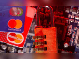 Mastercard credit cards and a padlock on a computer motherboard