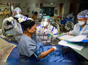 Varanasi: Nurses treat a COVID-19 patient at a hospital in Varanasi. (PTI Photo)...