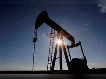 FILE PHOTO: The sun is seen behind a crude oil pump jack in the Permian Basin in Loving County