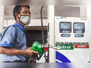 Mumbai: An attendant of a fuel station works, as petrol price nears the 100 rupe...