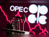FILE PHOTO: FILE PHOTO: A 3D printed oil pump jack is seen in front of displayed stock graph and Opec logo in this illustration picture