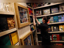 An employee of the Harry Potter New York store pulls a book from a shelf  during press preview in the Flatiron district of New York City