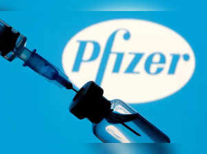 FILE PHOTO: Vial and syringe are seen in front of displayed Pfizer logo