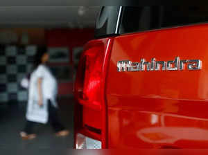 FILE PHOTO: An employee walks past a Mahindra TUV300 car at a showroom in Mumbai