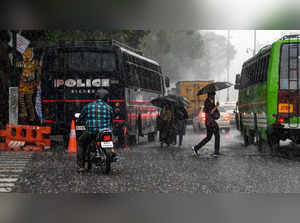 Thiruvananthapuram: Vehicles ply on a road during a pre-monsoon showers, in Thir...
