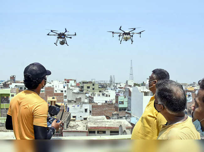 Workers fly drones for aerial sanitizing in Varanasi