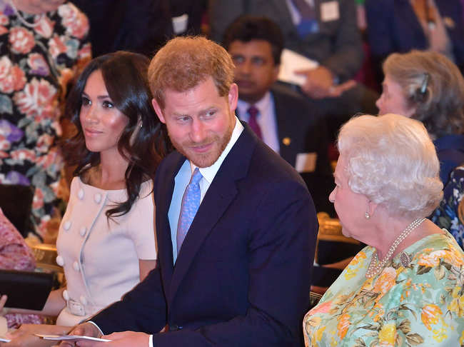 File photo of June 26, 2018: Queen Elizabeth II with Prince Harry and Meghan Markle at the Queen's Young Leaders Awards Ceremony at Buckingham Palace in London, England.