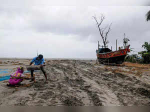 South 24 Parganas: Villagers try to save their boat at Fraserganj, ahead of land...