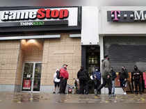 FILE PHOTO: Outside a GameStop store people line up to purchase a Sony PS5 gaming console