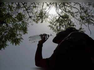 Amritsar:  A youngster drinks water on a hot summer day in Amritsar. (PTI Photo)...