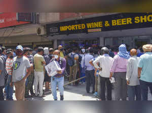New Delhi: People gather in large numbers outside liquor shop after lockdown  an...