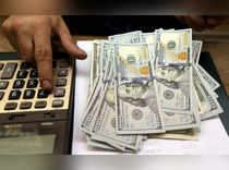 FILE PHOTO: An employee counts U.S. dollar bills at a money exchange office in central Cairo