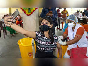 Burdwan: A girl takes selfie as she receives a dose of COVID-19 vaccine, at a va...