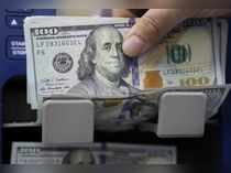 A man counts U.S. dollar banknotes at a currency exchange shop in Beirut