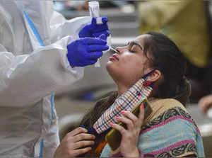 Bengaluru: A health worker collects swab sample of a passenger for COVID-19 test...