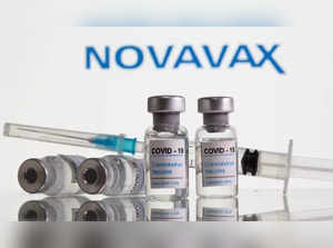 FILE PHOTO: Vials labelled "COVID-19 Coronavirus Vaccine" and syringe are seen in front of displayed Novavax logo in this illustration