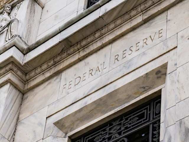 Fed indicates earlier rate hike