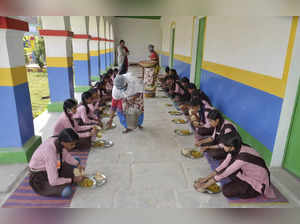 Students have mid-day meal at a government school
