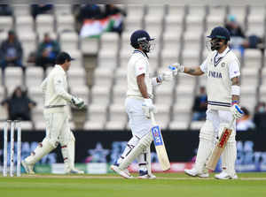Southampton: India's Ajinkya Rahane, center, fist bumps with captain Virat Kohli...