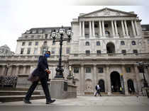 FILE PHOTO: A person walks past the Bank of England in the City of London financial district