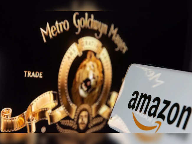 Smartphone with Amazon logo is seen in front of displayed MGM logo in this illustration taken