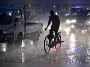 Jabalpur: Commuters on a road during heavy monsoon rain in Jabalpur. (PTI Photo)...