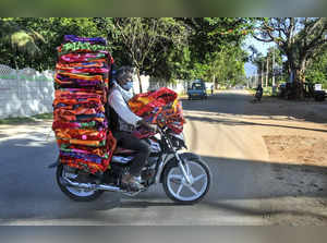 A vendor carries blankets on his motorcycle for sale after further ...