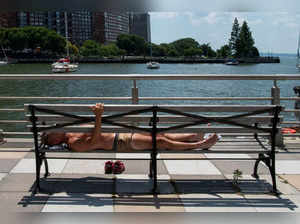A man sunbathes during a heat wave in New York City