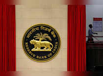 FILE PHOTO: A worker walks past the logo of Reserve Bank of India inside its office in New Delhi