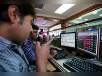 Brokers trade on computer terminals at a stock brokerage firm in Mumbai